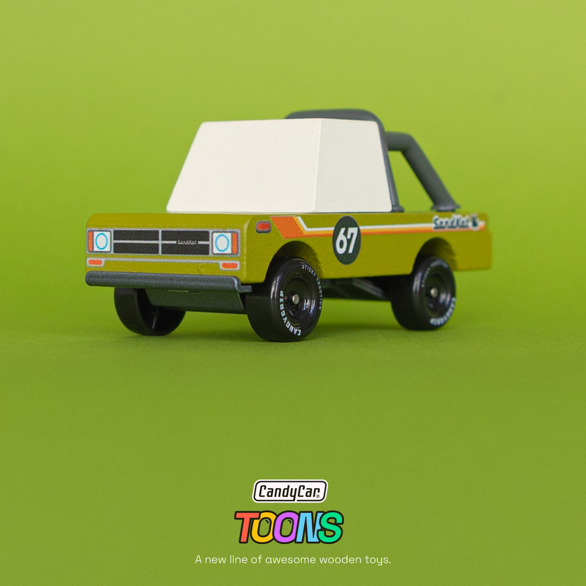 Wooden toy truck CandyCar Toons Sand Kat Adventure in olive green with a white top and racing number 67 on a green background.