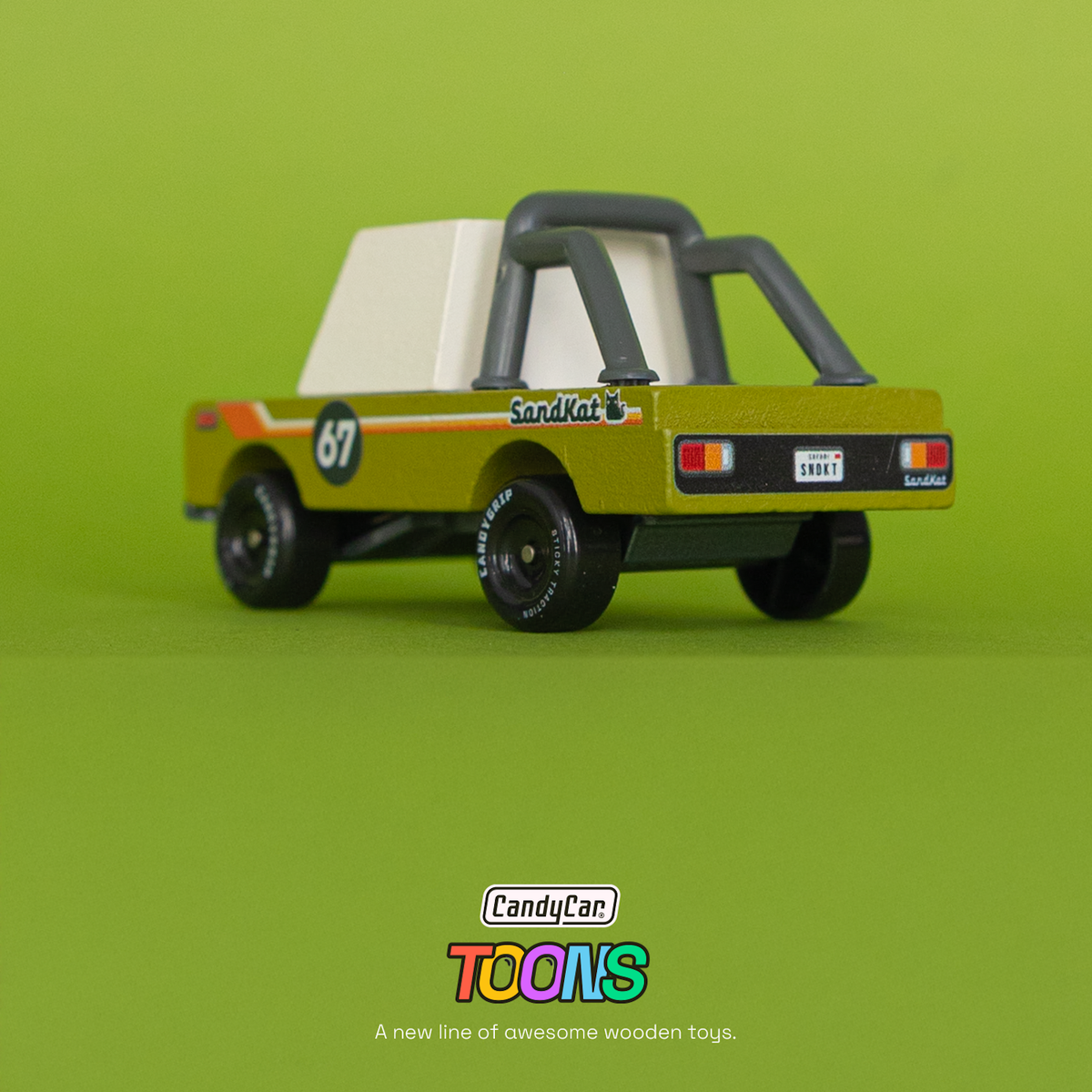 Candycar Toons Sand Kat wooden toy truck in olive green with a roll cage and retro racing graphics against a green background.
