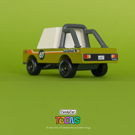 Candycar Toons Sand Kat wooden toy truck in olive green with a roll cage and retro racing graphics against a green background.
