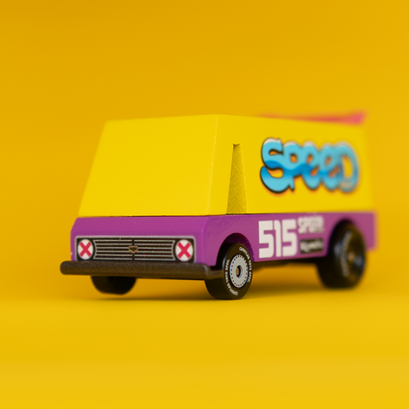 Front view of a Candylab Speed Vandal wooden toy van with a yellow top, purple base, and "Speed" graffiti on a yellow background.