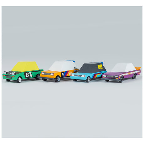 Four wooden toy race cars with colorful geometric designs and numbers from the Candylab Candycar Tokyo Heat collection.