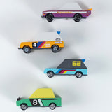 Four colorful Candylab Candycar wooden toy cars in a minimalist design, inspired by Tokyo drift and vintage racing styles.
