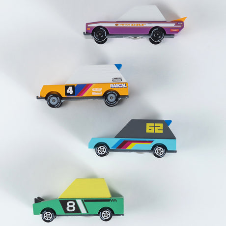 Four colorful Candylab Candycar wooden toy cars in a minimalist design, inspired by Tokyo drift and vintage racing styles.