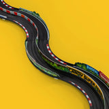 Candylab Roadworks 60-degree turn track expansion set with curved black racing lanes and colorful guardrails on yellow.