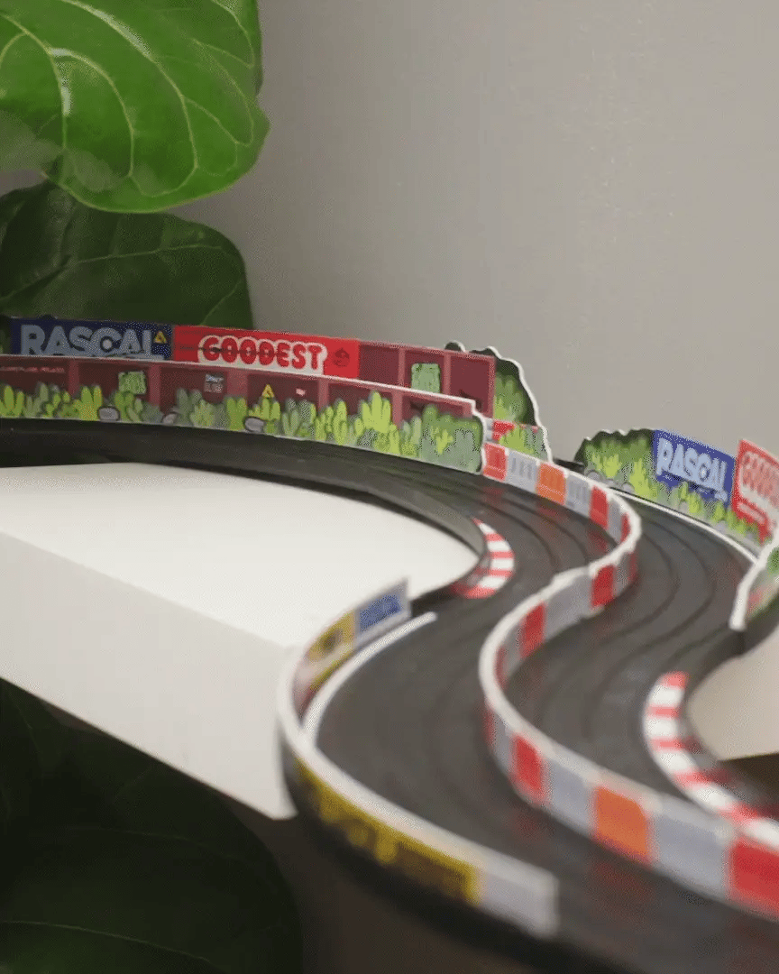 Candylab Roadworks 60-degree turn track expansion with RASCAL and GOODEST racing barriers on a curved toy race track.