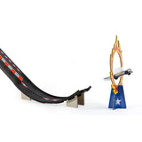 Toy car jumping through a flaming hoop from a black Candylab Roadworks stunt ramp on a clean white background.