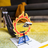 Candylab Roadworks Stunt Jump playset featuring a toy car jumping through a flaming hoop on a yellow rug.