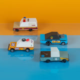 Four stylized wooden toy cars by Candylab Toys on an orange and blue background, including a sheriff car and race cars.