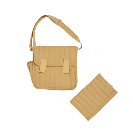 Honey-colored quilted convertible diaper bag with matching changing mat on a white background.