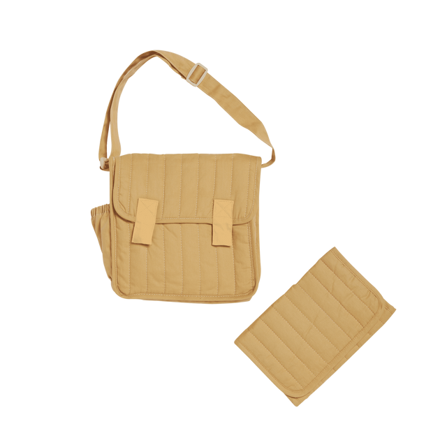 Honey-colored quilted convertible diaper bag with matching changing mat on a white background.