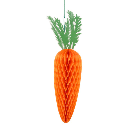 Large orange honeycomb paper carrot decoration with green paper leaves hanging on a white background.