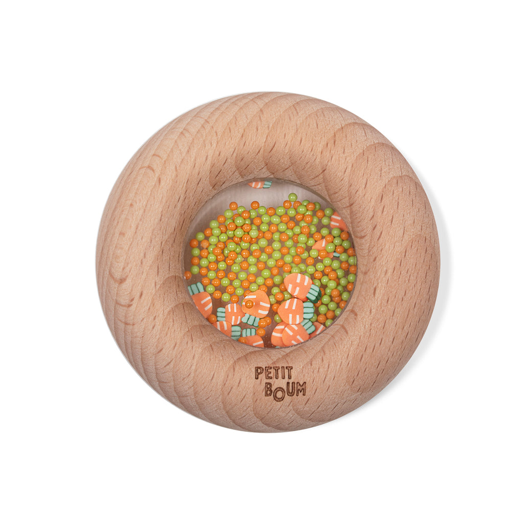 Petit Boum Sensory Donut - Carrot edition, wooden baby toy with orange and green beads inside a clear window."