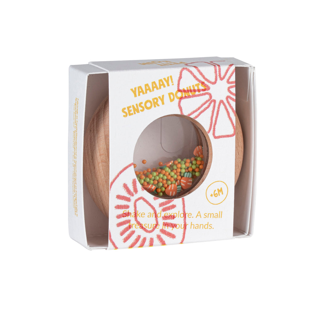Petit Boum Sensory Donut - Carrot edition, in eco-friendly packaging with an orange and yellow citrus-inspired design, suitable for babies 6 months and older
