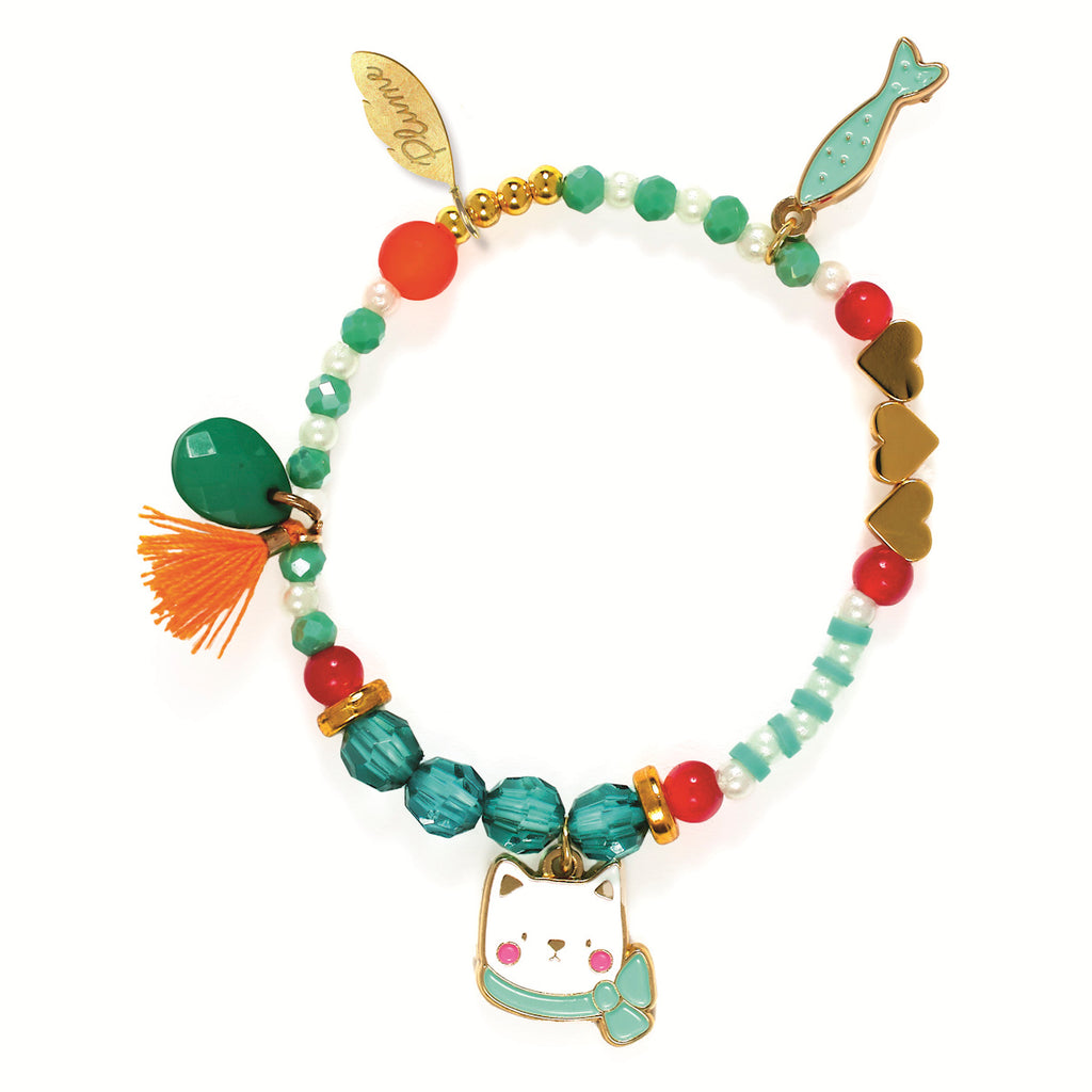 Colorful charm bracelet with beads, hearts, tassels, and cat and mermaid charms. Includes green, red, and gold accents, evoking a playful mood.