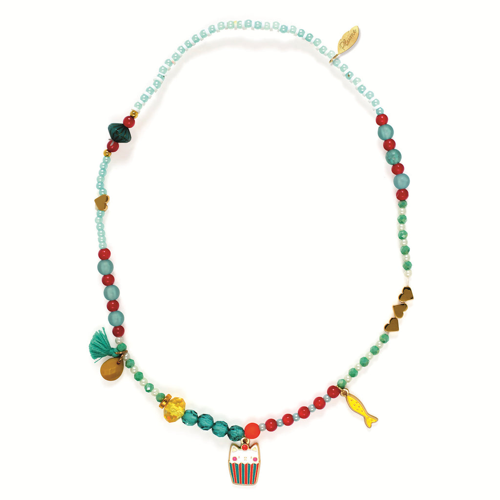 Colorful beaded necklace with varied shapes and charms, including a fish and cat. Features turquoise, red, and gold beads, creating a playful, whimsical tone.