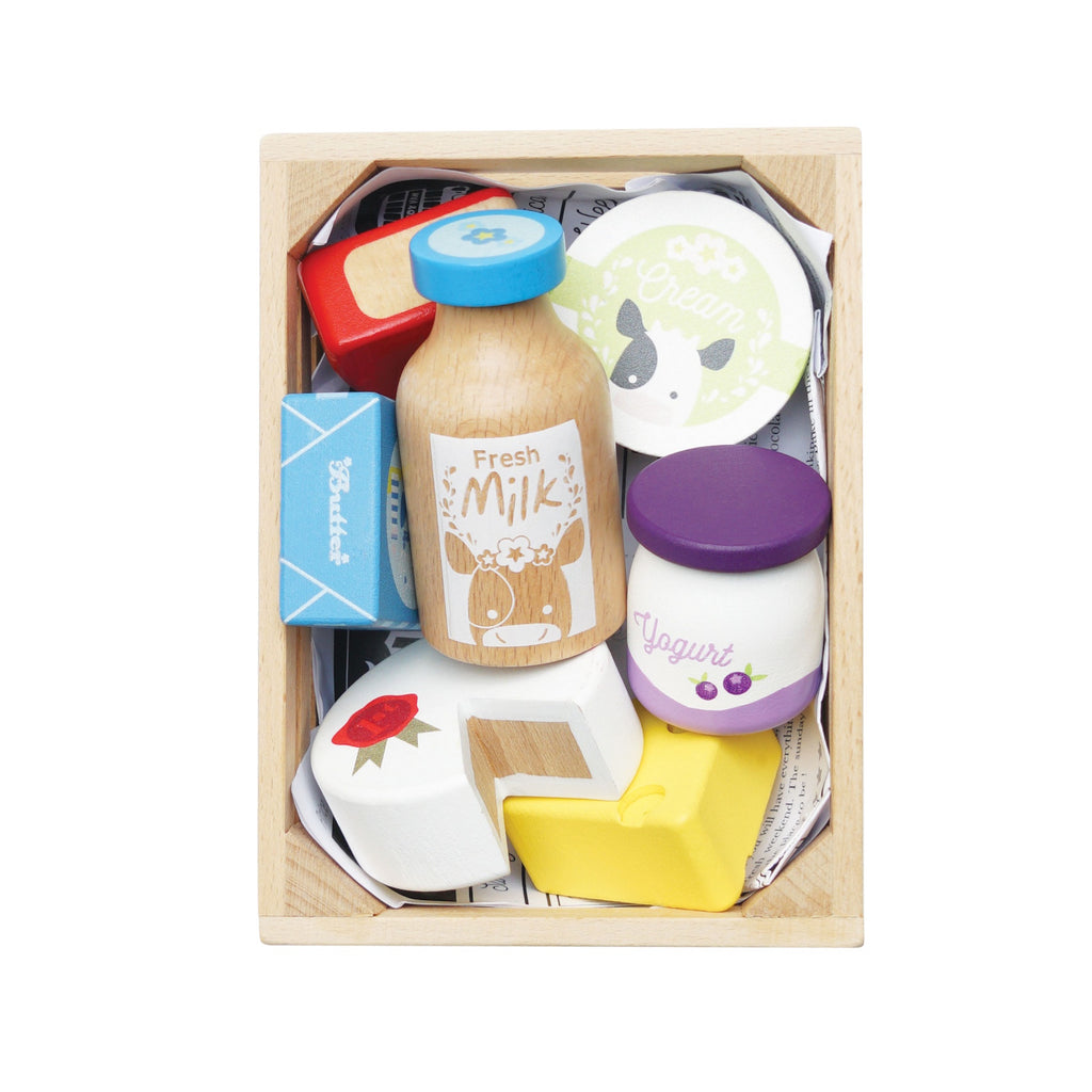 Wooden toy crate containing colorful toy groceries: milk bottle, cheese, yogurt, and cream. Bright, playful, and inviting.