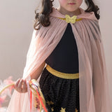 Close-up of a child wearing a light pink glitter dress-up cape with a gold butterfly clasp and gold skirt.