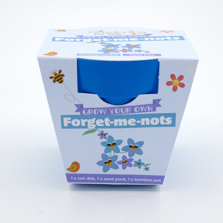 Blue packaging for a "Grow Your Own Forget-me-nots" kit featuring a blue bamboo pot inside.
