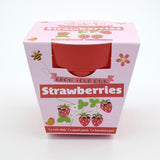 Pink packaging for a "Grow Your Own Strawberries" kit with a red bamboo pot inside.