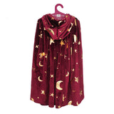 Burgundy velvet children's wizard cape with gold foil stars and moons on a hanger.