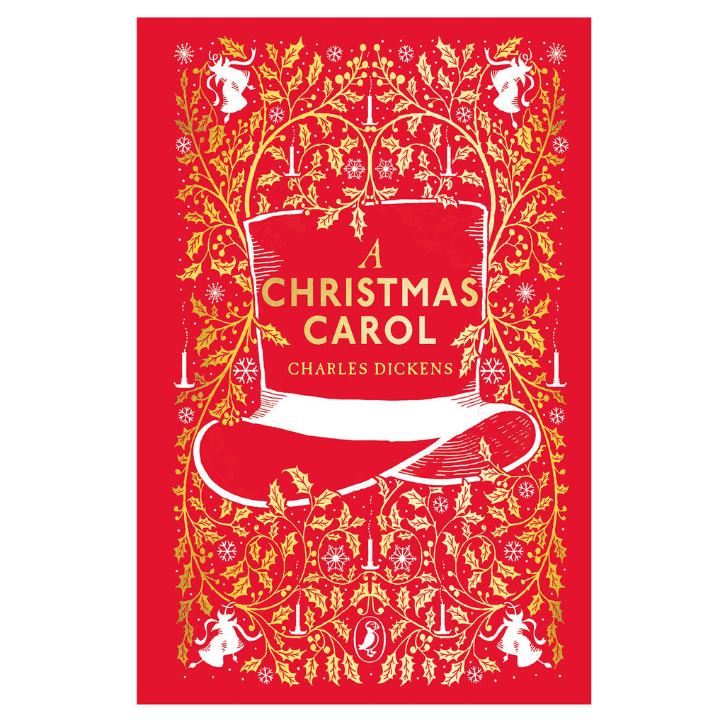 Red book cover of "A Christmas Carol" by Charles Dickens. Features a gold ornate design with holly leaves, candles, and festive motifs, centered around a top hat.
