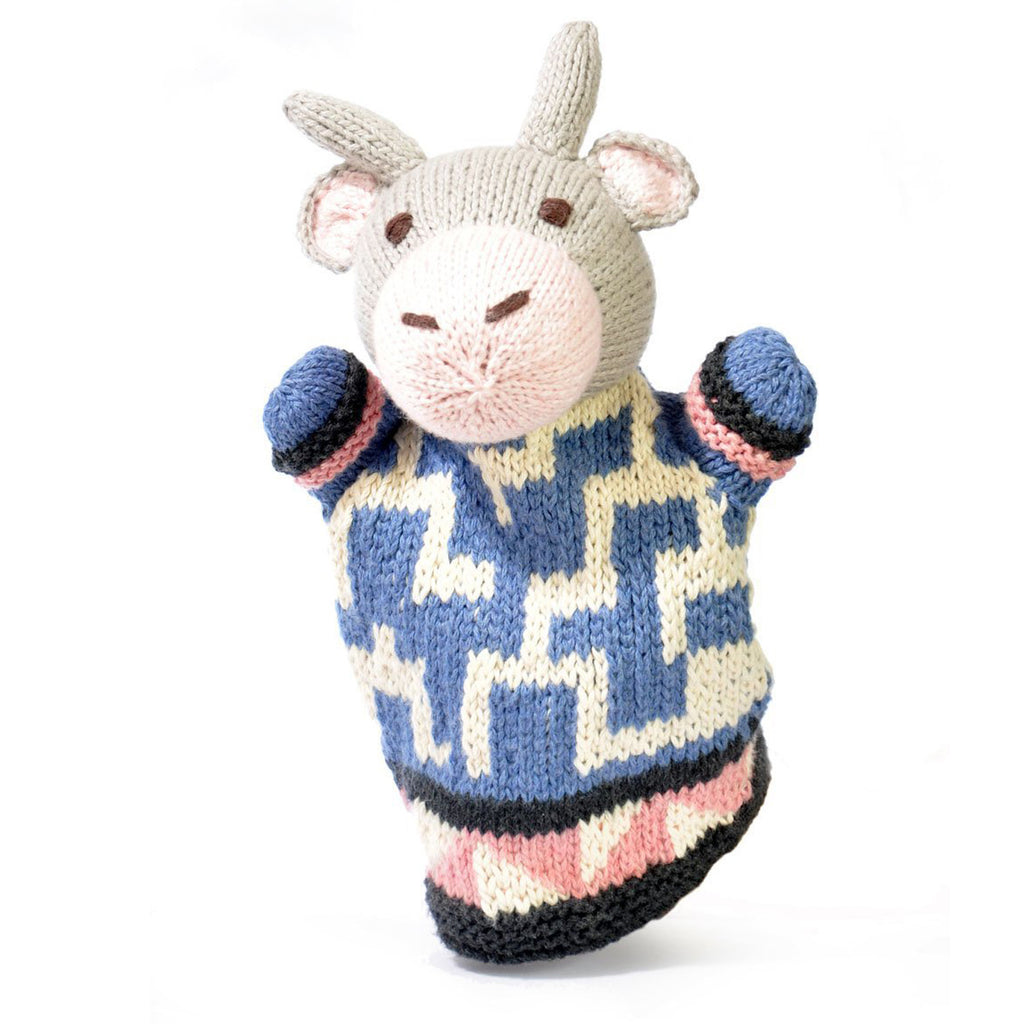 Knitted hand puppet of a gray cow with beige snout and ears, wearing a blue and cream zigzag-patterned sweater. It conveys a playful, whimsical tone.