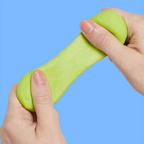 Two hands pulling and stretching light-green focus putty against a solid blue background.