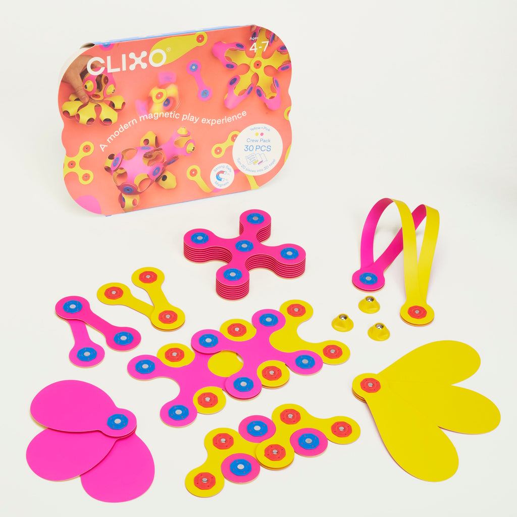 Brightly colored magnetic play set with pink and yellow pieces featuring circular connectors. Box labeled "Clixo" for ages 4-7. Energetic and playful theme.