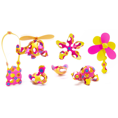 Various 3D shapes, structures, and figures built from pink and yellow magnetic Clixo pieces on a white background.