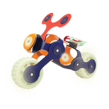 A toy motorcycle built with flexible Clixo magnetic pieces and glowing green wheels against a white background.