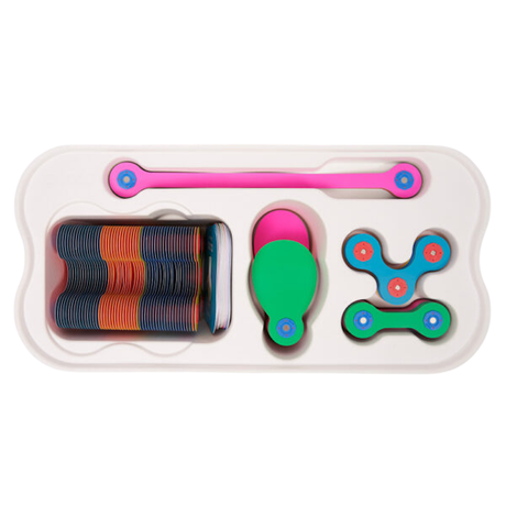 A plastic tray organized with colorful magnetic building toy pieces in pink, blue, green, and orange.