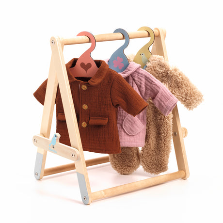 Wooden doll clothes rack with miniature jackets and hangers for pretend play.
