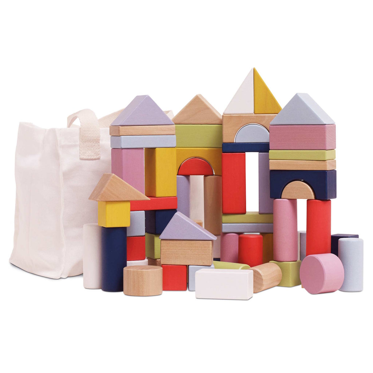 Colorful wooden building blocks stacked into castle shapes next to a white canvas storage bag.
