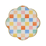 Scalloped side plate with a gold rim and colorful checkered pattern.