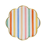 Scalloped side plate with a gold rim and colorful vertical stripes.