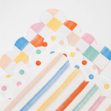 A stacked arrangement of colorful pattern napkins featuring checkered, polka dot, and striped designs.