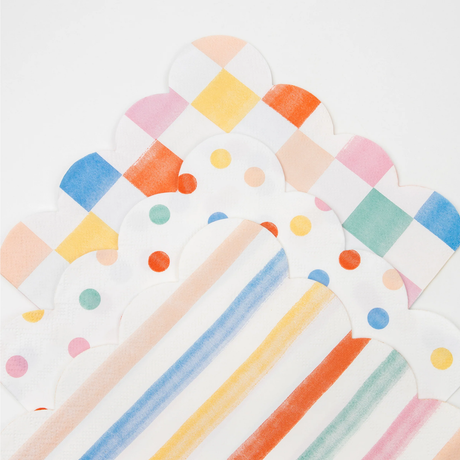 A stacked arrangement of colorful pattern napkins featuring checkered, polka dot, and striped designs.