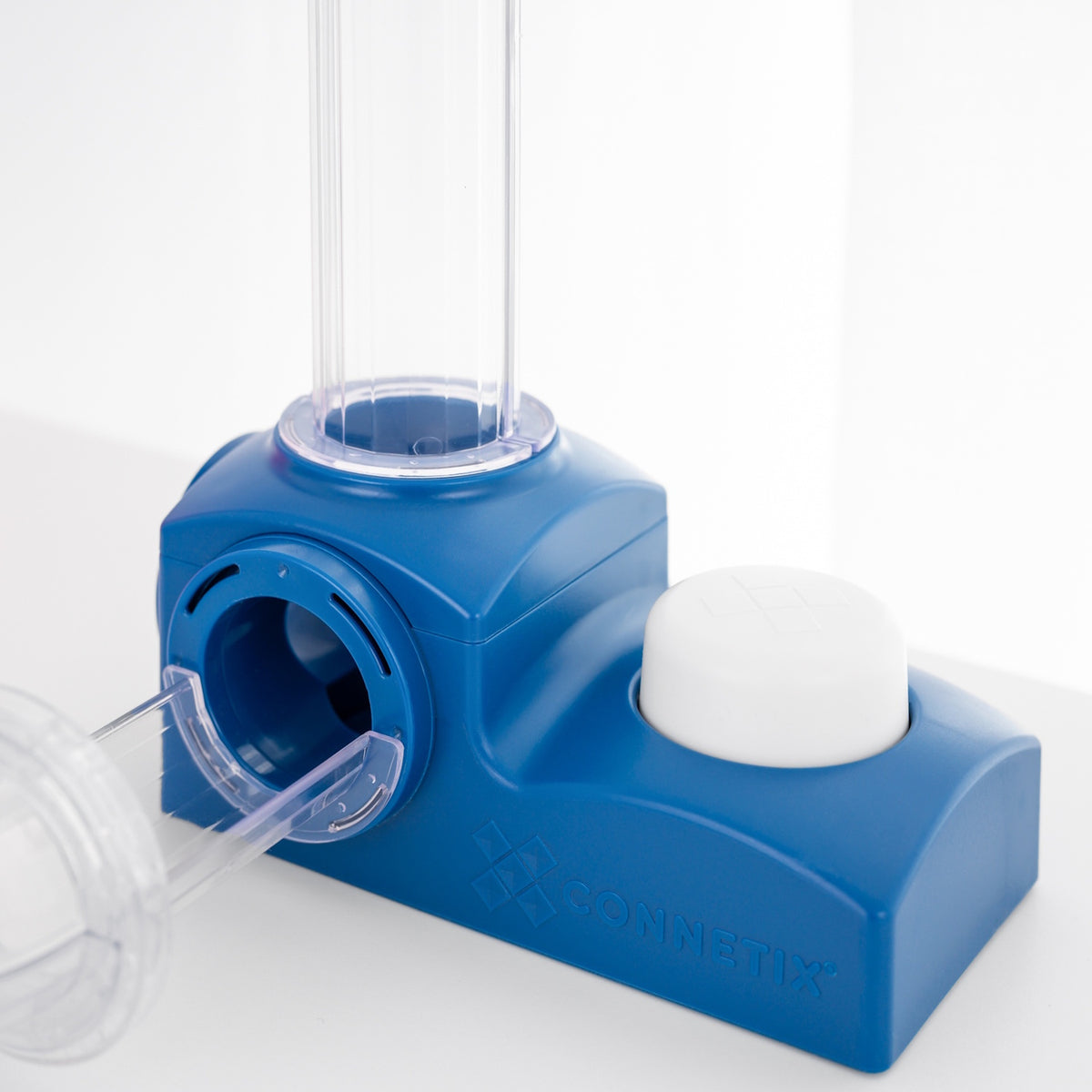 Blue magnetic tile ball launcher component with a white push button and clear plastic tubes attached.