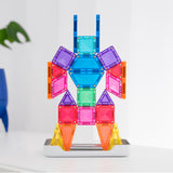 Colorful magnetic tile figure built in a robot shape with blue, purple, pink, and yellow geometric pieces.