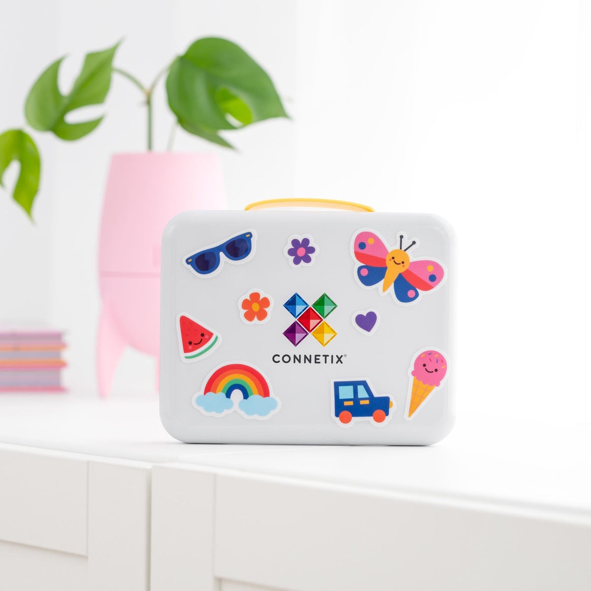 White Connetix travel case decorated with colorful stickers of a butterfly, rainbow, and ice cream.