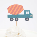 Blue cement mixer truck cupcake topper with an orange striped drum on a wooden pick in swirled white frosting.