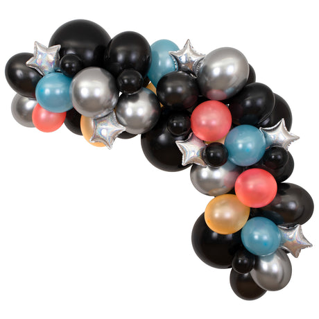 Assembled cosmic balloon arch kit showcasing black, silver, blue, and coral balloons with silver star foil accents.