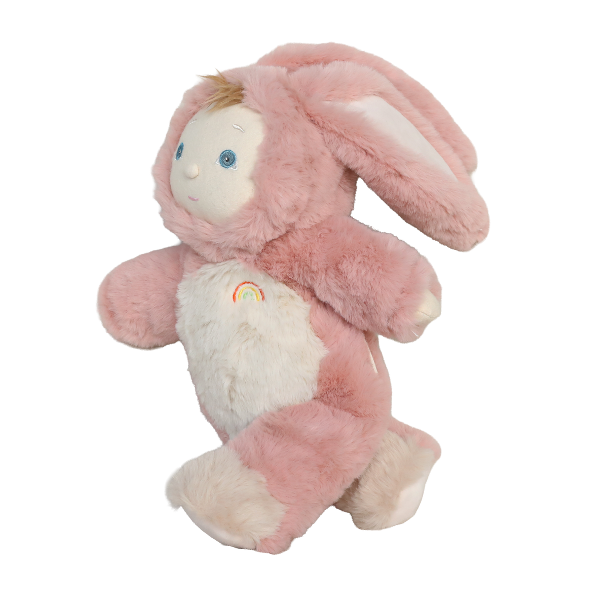 Side view of a plush baby doll in a fuzzy pink bunny suit with floppy ears and a rainbow emblem.