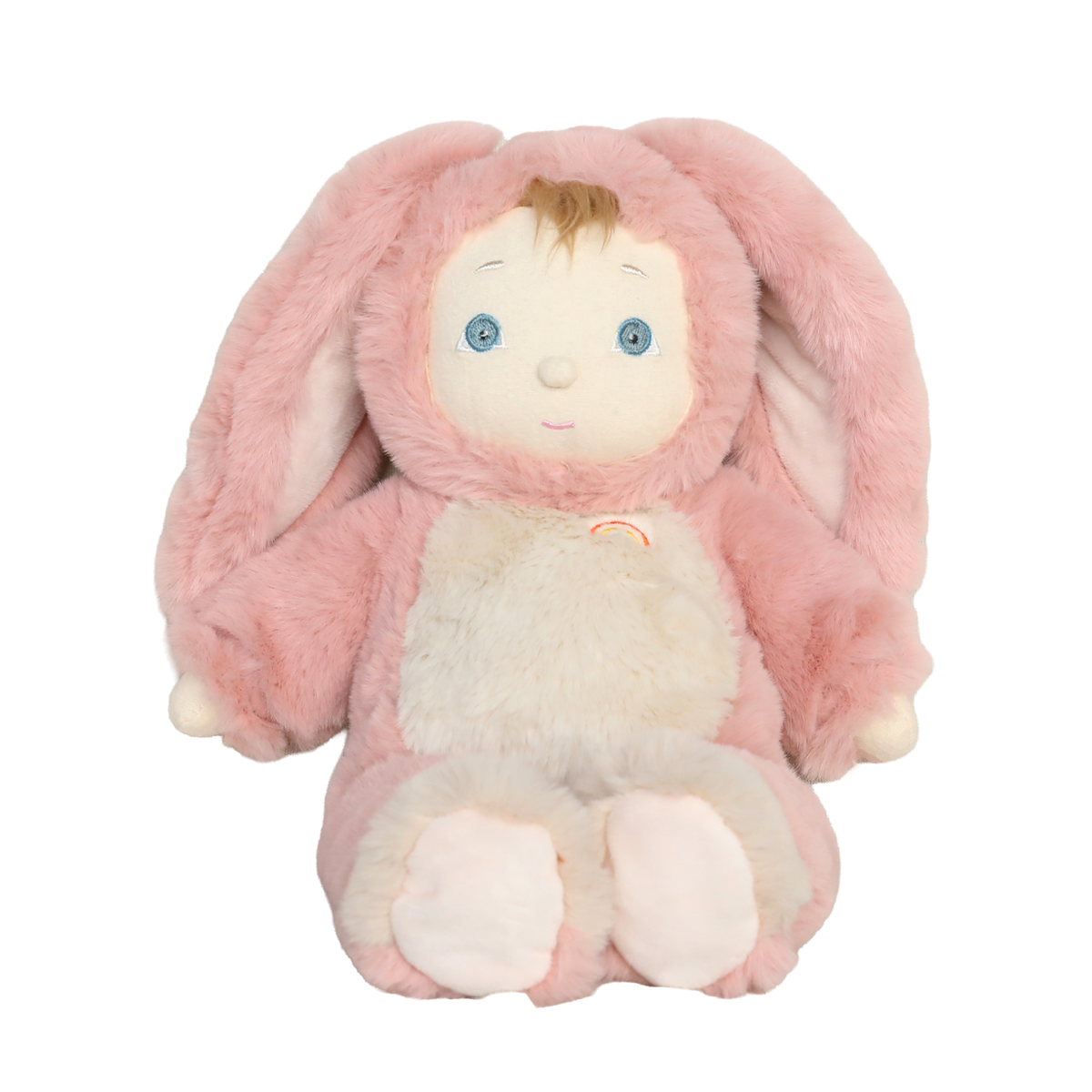 Plush baby doll wearing a fuzzy pink bunny suit with long floppy ears and a small rainbow patch.