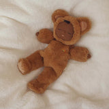 Olli Ella Cozy Dinkum Teddy Mini Caramel doll sleeping on a soft white blanket.