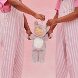 Two children in pink overalls holding a Cozy Dinkums Sweetpea unicorn plush doll.