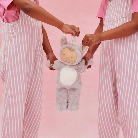 Two children in pink overalls holding a Cozy Dinkums Sweetpea unicorn plush doll.