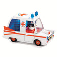 The ambulance is crafted from metal with a distinctive, colorful design. It includes a pilot character whose head can rotate, adding to the interactive play experience.