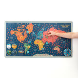 A hand placing a pop-up piece onto a large, colorful world map labeled "Animal Kingdom Giant Map."