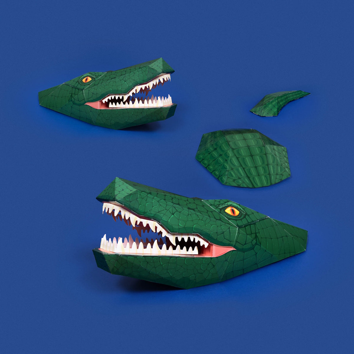 3D papercraft green crocodile model assembled in sections set against a solid blue background.